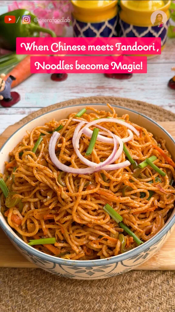 Smoky tandoori Chinese noodles served in a bowl with spring onion garnish